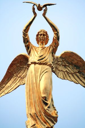 Object. Monument golden angel in blue sky.の写真素材