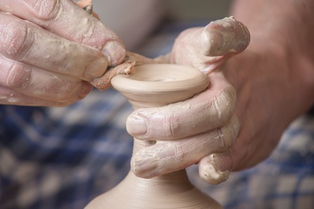 Hands of a potter, creating an earthen jar on the circleの写真素材