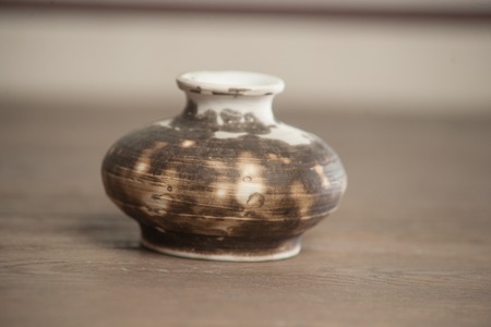 Traditional handcrafted vase of brown color on the tableの写真素材