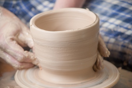 Hands of a potter, creating an earthen jar on the circleの写真素材