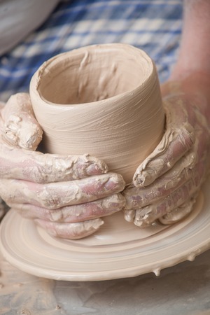 Hands of a potter, creating an earthen jar on the circleの写真素材
