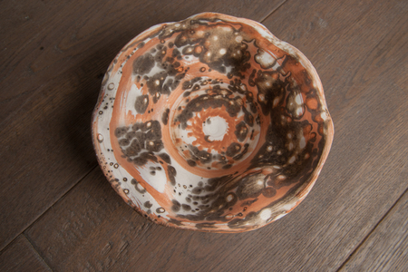 Traditional handcrafted dish of brown color on the tableの写真素材