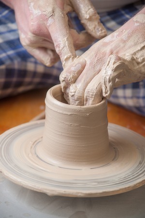 Hands of a potter, creating an earthen jar on the circleの写真素材