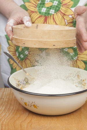 Women's hands prepairing flour before baking pie.の写真素材