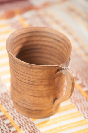 Traditional handcrafted mug on the multycolor backgroundの写真素材