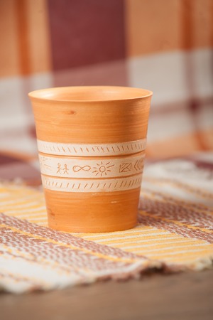 Traditional handcrafted mug on multycolor background. High resolutionの写真素材