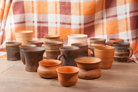 Set of traditional handcrafted mugs on the wooden tableの写真素材