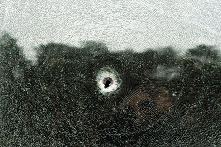 Abstract image of broken glass texture, background. Close-up of a broken car windshield. Broken and...
