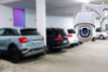 CCTV security camera on blur car parking. copy space