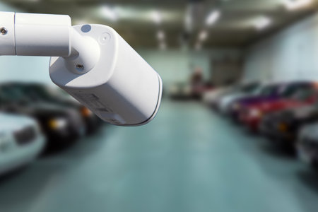 CCTV security camera on blur car parking. copy space