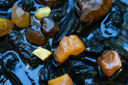 Amber stone in a mountain river. Gemstone, treasure conceptの写真素材