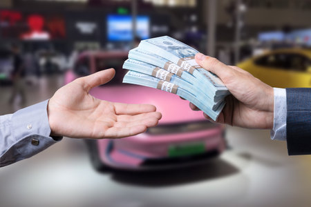 Purchase deal of buy or rent new car. Hand with dollar money and car keys. financeの写真素材