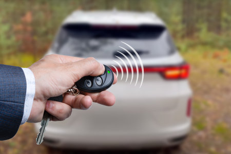 Men's hand presses on the remote control car alarm systemsの写真素材