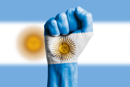 Man hand fist of ARGENTINA flag painted. Close-upの写真素材