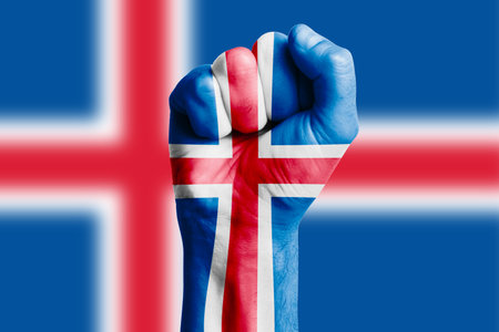 Man hand fist of ICELAND flag painted. Close-upの写真素材