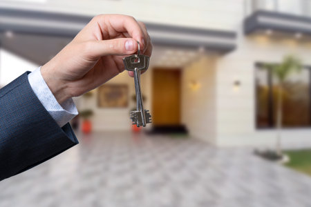 Man hand holding on finger keys to new houseの写真素材