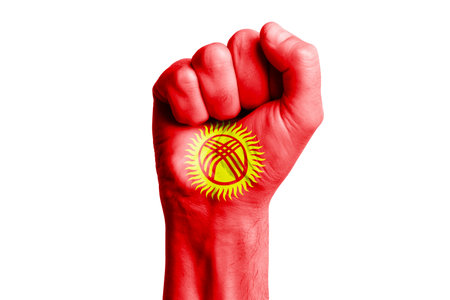 Man hand fist of KYRGYZSTAN flag painted. Close-upの写真素材