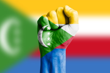 Man hand fist of COMOROS flag painted. Close-upの写真素材