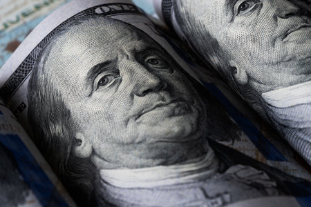 Macro shot of a brand new one hundred dollar bill showing the face of Benjamin Franklin
