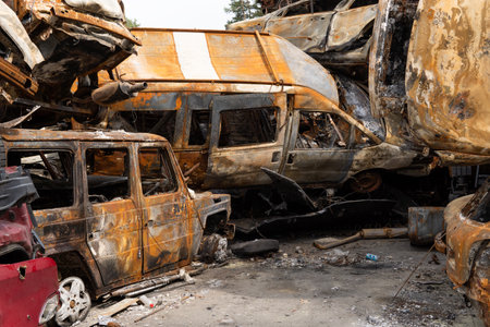 war in Ukraine. Car graveyard. Cars of civilians were shot. Russia's war against Ukraine. Burnt and...