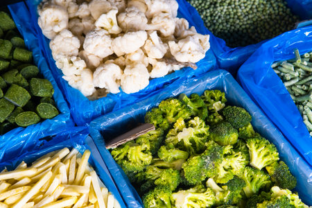 Assortment of frozen vegetables in a supermarket fridgeの写真素材