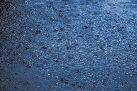 Rain water drop falling to the floor in heavy rain day