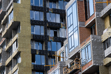 Installation of external thermal insulation of walls with mineral wool. Insulation of the facade of a multi-storey residential building. energy efficiency.の写真素材