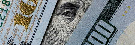 Image focusing on the face of Benjamin Franklin on the US 100 bill with high-definition details.の写真素材