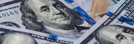 High-resolution image capturing the detailed portrait of Benjamin Franklin on the US 100 bill.