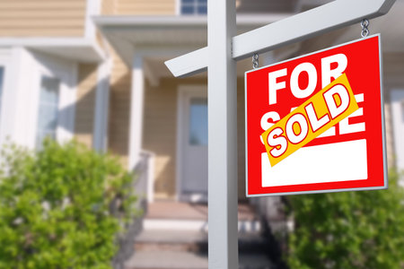 Sold Home For Sale Sign in Front of New Houseの写真素材