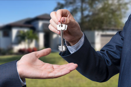 Handing the home keys between realtor and new owner. sale conceptの写真素材