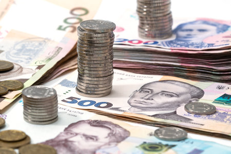 heap of different Ukrainian hryvnia in isolated background.