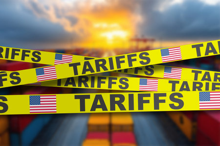 Industrial shipping crates covered with American tariff tape, showing global trade tensions.の写真素材