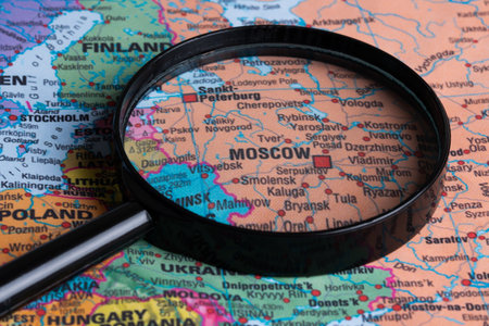 Magnifying glass highlighting Moscow on a detailed world map