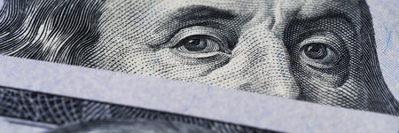 a detailed look at Benjamin Franklins face on the iconic hundred-dollar bill.の写真素材