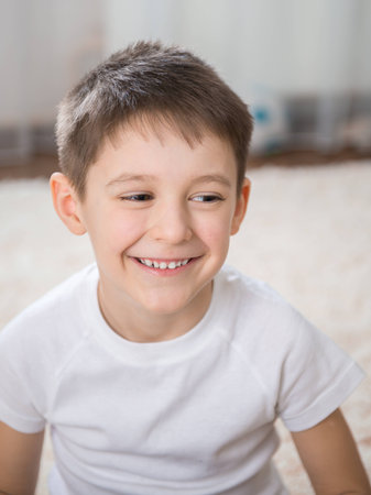 Smiling little boy indoor closeup portrait