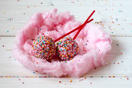 Cakepops in the nest made from candy-floss, white backgroundの写真素材