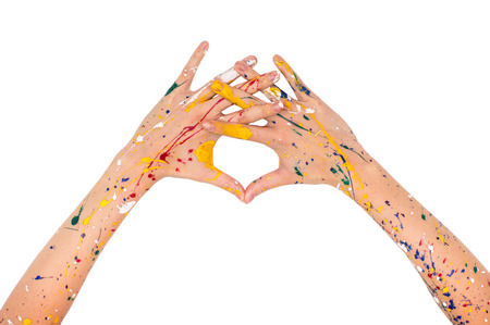 Woman hands in paint make a free shape isolated on white backgroundの写真素材