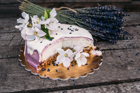 Closeup of the  lavender cheesecake and bouquet with apple flowers on the old planks, sectionの写真素材