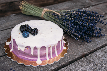 Closeup of the  lavender cheesecake with berries  on the old planksの写真素材