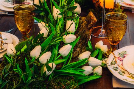 Wedding table decorations with tulips and moss