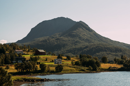 Houses and mountains near Holmstad, Lofoten Islands, Norwayの写真素材
