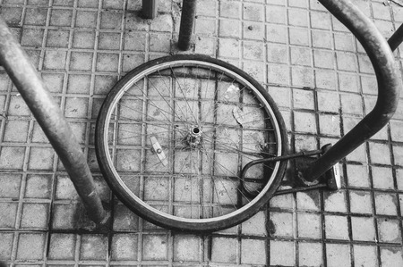 Bicycle wheel with locker lay on the street, stolen bicycleの写真素材