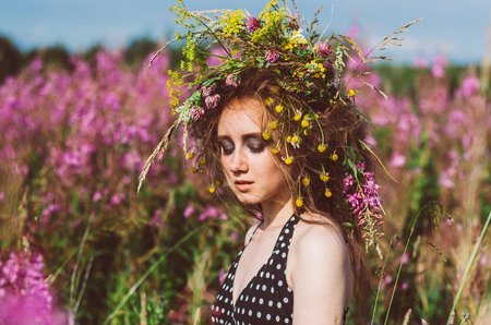 Portrait of young girl with closed eyes in willow-herb fieldの写真素材
