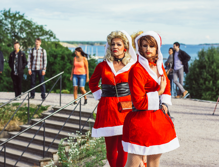 Helsinki, Finland - June 30, 2018: Participants in Santa Claus wearings on Helsinki pride festival in Kaivopuisto gardenのeditorial素材