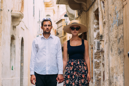 Man holds woman by hand in old city, Gozo, Maltaの写真素材