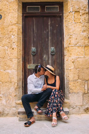 Man kissing woman in old city, Gozo, Maltaの写真素材