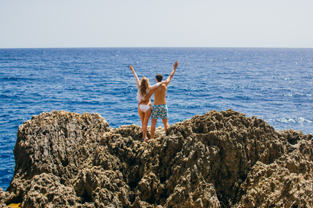 Man and woman together on the coastline, sea on background, Maltaの写真素材