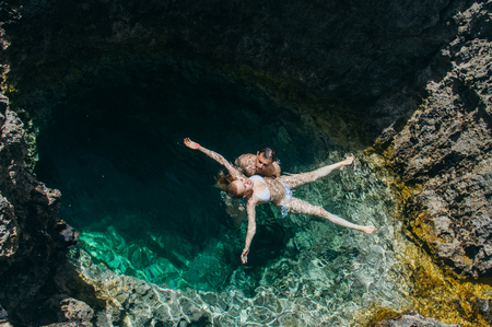 Man and woman together swim in the pool, Maltaの写真素材