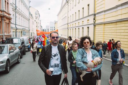 Helsinki, Finland - June 29, 2019: Couple with dog on hands on Helsinki Pride festival on the streetのeditorial素材